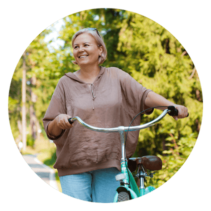 Mature women pushing her bike