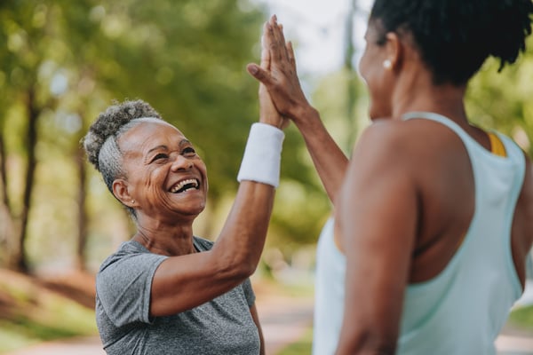 Mature woman high-fiving another woman